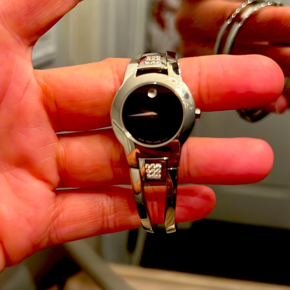 Movado silver and black watch with diamonds.